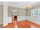 Dining room featuring hardwood floors, chair rail, decorative trim, and chandelier at 52 Olivia Ct, Palmetto, GA 30268