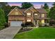 Charming two-story brick home with a well-manicured lawn, attached garage, and inviting front porch at 52 Olivia Ct, Palmetto, GA 30268