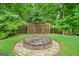 Welcoming backyard fire pit area set in a peaceful wooded setting at 52 Olivia Ct, Palmetto, GA 30268