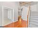 Welcoming foyer featuring hardwood floors, staircase, and open access to other rooms at 52 Olivia Ct, Palmetto, GA 30268