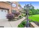 Beautiful brick home featuring lush landscaping along walkway leading to the front porch at 52 Olivia Ct, Palmetto, GA 30268