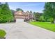 Traditional brick home with manicured lawn, mature trees, and a spacious driveway at 52 Olivia Ct, Palmetto, GA 30268