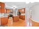 Eat-in kitchen has an island, granite countertops, stainless appliances and wood floors at 52 Olivia Ct, Palmetto, GA 30268
