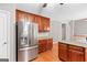 Kitchen with stainless steel refrigerator, granite countertops, and wooden cabinets at 52 Olivia Ct, Palmetto, GA 30268