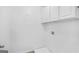 Bright laundry room has white cabinets and walls with access for washer and dryer hookups and plenty of storage at 52 Olivia Ct, Palmetto, GA 30268