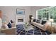 Cozy living room with fireplace, large windows, and comfortable seating at 52 Olivia Ct, Palmetto, GA 30268