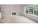 Living room with fireplace and large window with backyard views at 52 Olivia Ct, Palmetto, GA 30268