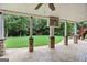 Covered patio with stone columns overlooks a beautiful green lawn at 52 Olivia Ct, Palmetto, GA 30268