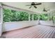 Spacious screened porch with wood ceiling and floors overlooks private backyard at 52 Olivia Ct, Palmetto, GA 30268