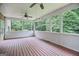Large screened porch with wooded views, ceiling fans and wood flooring at 52 Olivia Ct, Palmetto, GA 30268