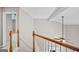 Bright staircase with wood railings and neutral walls leads to the upper level at 52 Olivia Ct, Palmetto, GA 30268