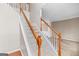 Bright staircase features carpeted steps, white spindles, and wooden handrail at 52 Olivia Ct, Palmetto, GA 30268