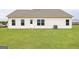 Spacious backyard with healthy lawn, rear home entry, and external AC unit at 280 Oliver Dr, Locust Grove, GA 30248