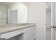 Contemporary bathroom featuring granite countertop, white cabinets, and large mirror at 280 Oliver Dr, Locust Grove, GA 30248
