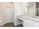 Modern bathroom with granite countertop, white cabinets, and wood-look tile flooring at 280 Oliver Dr, Locust Grove, GA 30248
