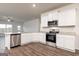 Beautiful kitchen with stainless steel appliances, white cabinetry, and stone counter tops at 280 Oliver Dr, Locust Grove, GA 30248