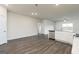 Open-concept area with hardwood floors, connecting the kitchen and living spaces at 280 Oliver Dr, Locust Grove, GA 30248