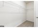 Walk-in closet featuring neutral walls, plush carpet flooring, and metal shelving at 280 Oliver Dr, Locust Grove, GA 30248