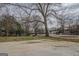 Large backyard with a concrete pad and mature trees providing shade at 4131 Carroll Sw St, Covington, GA 30014
