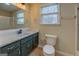 Bathroom featuring a white vanity top with dark green cabinetry and a large mirror at 4131 Carroll Sw St, Covington, GA 30014