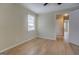 Empty bedroom featuring light-colored hardwood floors and neutral walls looking into adjacent room at 4131 Carroll Sw St, Covington, GA 30014