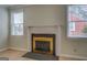Close-up of the fireplace with a white mantle and metallic gold fireplace screen at 4131 Carroll Sw St, Covington, GA 30014