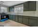 Kitchen featuring dark green cabinets, quartz countertops, and a stainless-steel appliance at 4131 Carroll Sw St, Covington, GA 30014