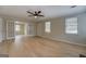 Bright living room with light-colored hardwood floors, ceiling fan, and french doors at 4131 Carroll Sw St, Covington, GA 30014
