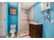 Updated bathroom features a modern shower, vanity, and toilet with bright blue walls at 734 Meadowlark Dr, Villa Rica, GA 30180