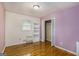 Bedroom with wood floors, open closet and window at 734 Meadowlark Dr, Villa Rica, GA 30180