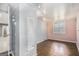 Cozy bedroom with wood floors, decorative wall mirror and bright window at 734 Meadowlark Dr, Villa Rica, GA 30180