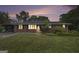 Charming single-story brick home featuring a well-maintained lawn and a cozy, inviting facade at dusk at 734 Meadowlark Dr, Villa Rica, GA 30180
