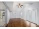 Open living room with wood floors, white walls, ceiling fan, and access to the kitchen with stainless steel appliances at 734 Meadowlark Dr, Villa Rica, GA 30180
