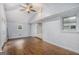 Light-filled living room featuring wood floors, a painted brick wall, and access to an adjacent room at 734 Meadowlark Dr, Villa Rica, GA 30180
