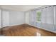 Comfortable living room with natural light, hardwood floors, and convenient access to the entryway and windows at 734 Meadowlark Dr, Villa Rica, GA 30180