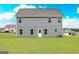 Spacious backyard of a grey two-story home with many windows overlooking the green grass at 284 Oliver Dr, Locust Grove, GA 30248