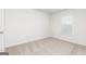 This bedroom offers neutral walls, carpet flooring, and a bright window at 284 Oliver Dr, Locust Grove, GA 30248