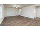 Spacious living room with ceiling fan, lots of natural light, and wood-look flooring at 284 Oliver Dr, Locust Grove, GA 30248