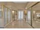 Spacious bathroom featuring dual vanities, a glass shower, tile floors, and mirrored closet doors at 111 Kenton Pl, Peachtree City, GA 30269