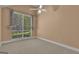Sunlit bedroom with wall-to-wall neutral carpet, ceiling fan, and window with curtains at 111 Kenton Pl, Peachtree City, GA 30269