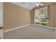 Well-lit bedroom with vaulted ceilings, a ceiling fan, large window and neutral colored walls and carpet at 111 Kenton Pl, Peachtree City, GA 30269