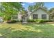 Charming one story home with mature landscaping, white trim and shutters at 111 Kenton Pl, Peachtree City, GA 30269