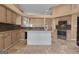 Traditional kitchen featuring an island, granite counters, light wood cabinets, and stainless steel appliances at 111 Kenton Pl, Peachtree City, GA 30269