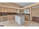 Traditional kitchen featuring an island, granite counters, light wood cabinets, and tile flooring at 111 Kenton Pl, Peachtree City, GA 30269