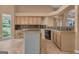 Traditional kitchen featuring an island, granite counters, light wood cabinets, and a black dishwasher at 111 Kenton Pl, Peachtree City, GA 30269