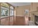 Open-concept living room featuring hardwood floors, a fireplace, and lots of natural light at 111 Kenton Pl, Peachtree City, GA 30269