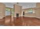 Large living room featuring hardwood floors, fireplace, and an open layout with views to kitchen and dining area at 111 Kenton Pl, Peachtree City, GA 30269
