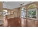 Spacious living room with hardwood floors, large windows, and an open floor plan to the kitchen at 111 Kenton Pl, Peachtree City, GA 30269