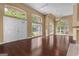 Open living space featuring dark hardwood floors and abundant natural light from many windows at 111 Kenton Pl, Peachtree City, GA 30269