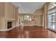 Open-concept living room featuring hardwood floors, a fireplace, and lots of natural light at 111 Kenton Pl, Peachtree City, GA 30269